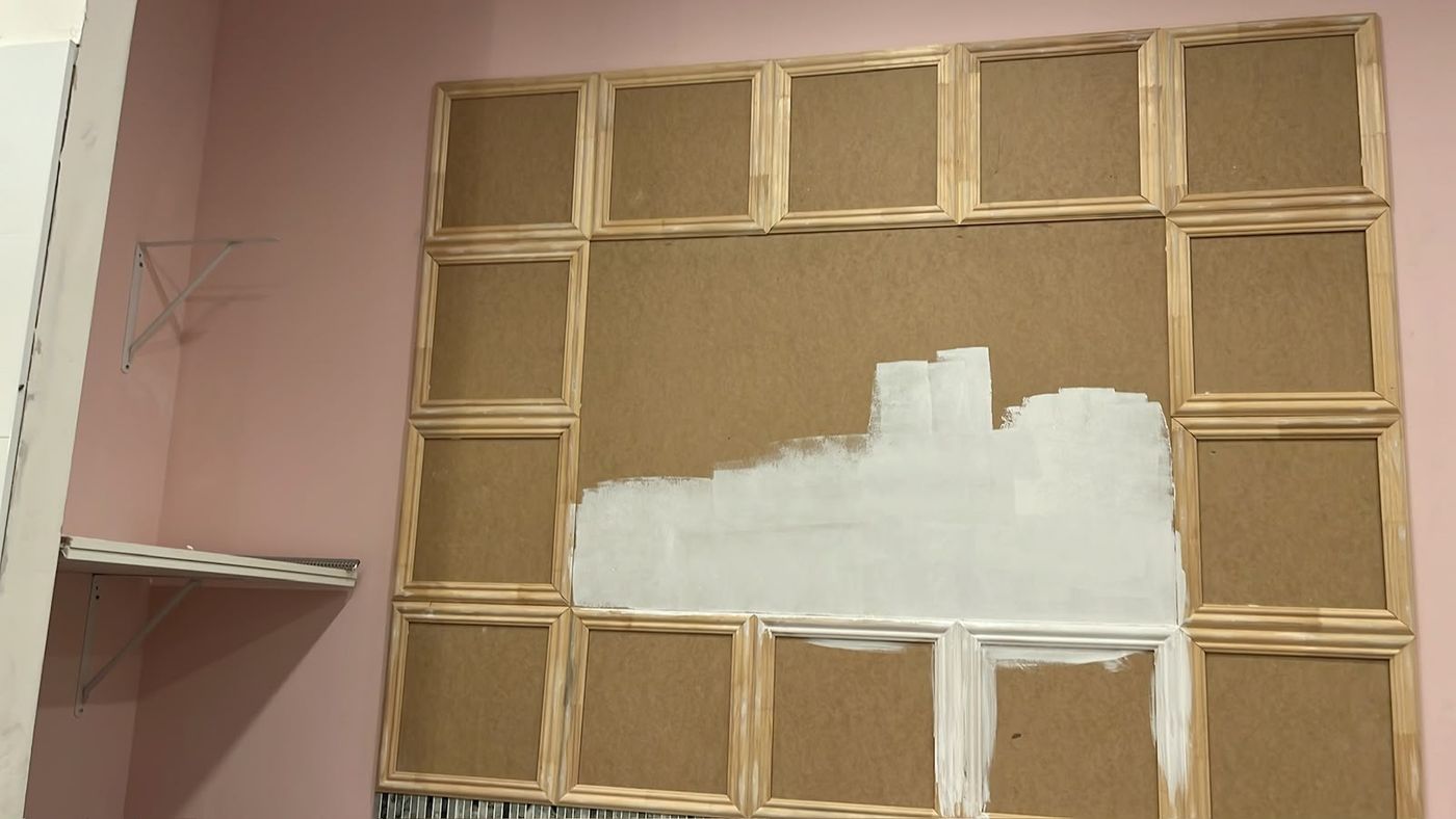 Panel wall with the first coat of primer going on